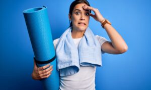 Woman making face like she made a mistake working out.